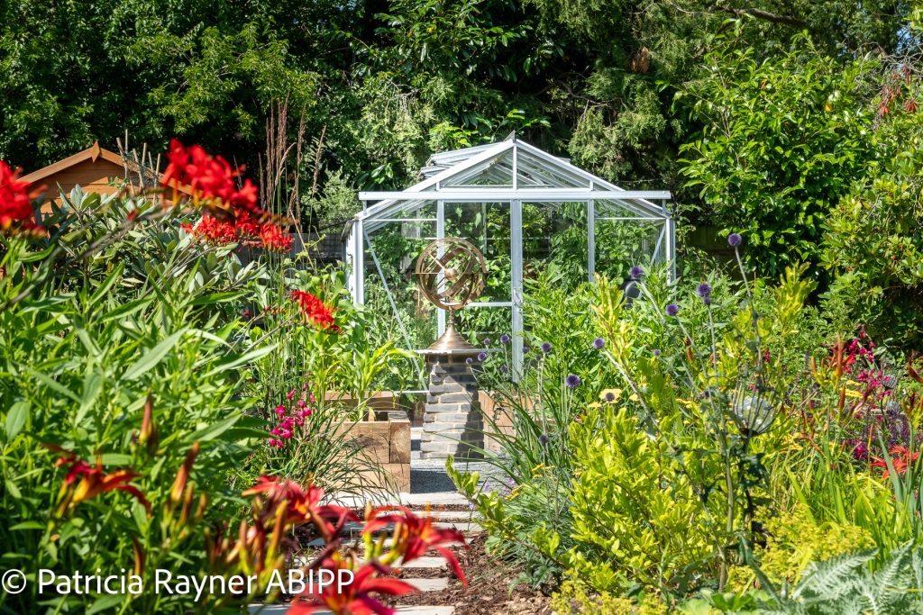 The lovely flowers showing another seating area in this lovely garden.