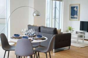 Interior modern room with table dressed for Dinner
