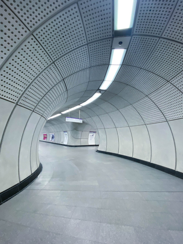 Wide architectural photograph of an ultra-modern underground transit station platform tunnel.Elizabeth line Line's beautiful structures.